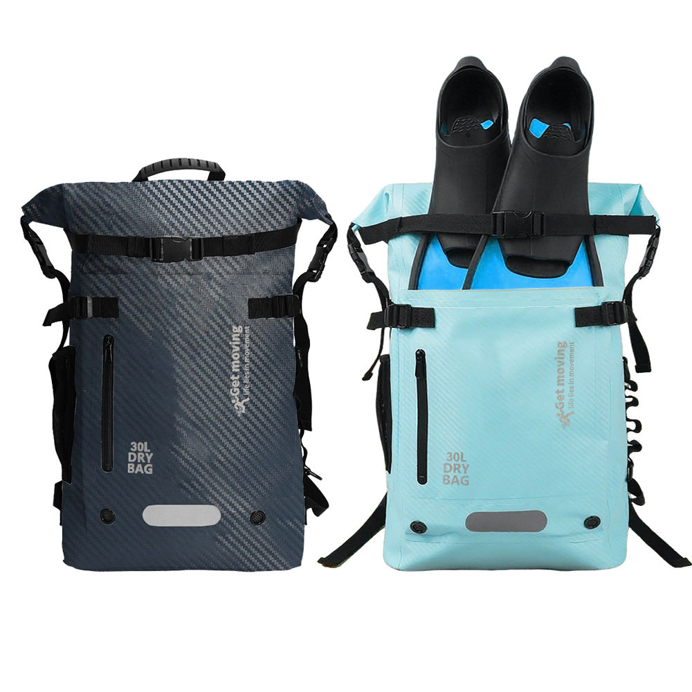 Dark grey and aqua fin-storage dry backpacks, with a pair of fins secured to the aqua bag