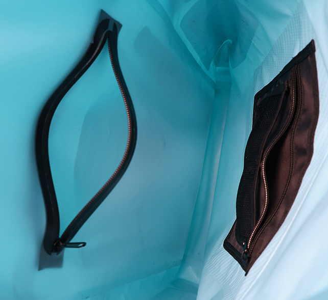 Close-up inside the aqua dry backpack showing two zippered storage pockets
